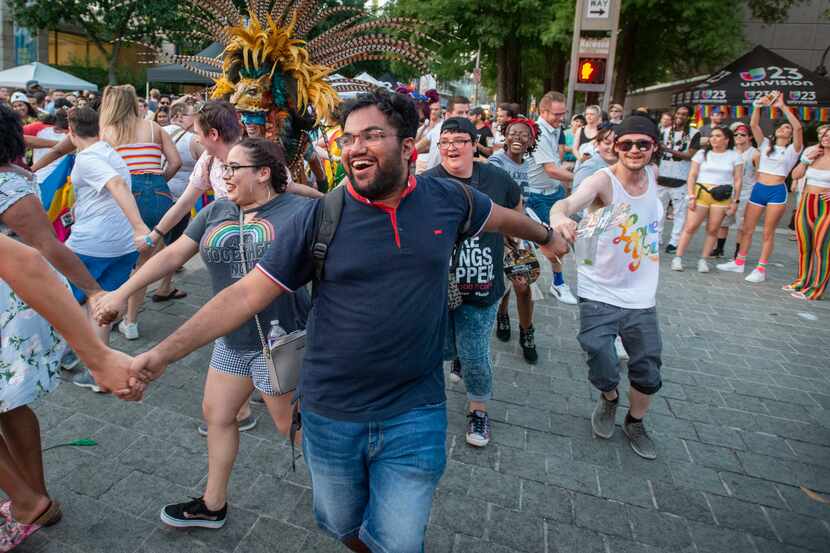 Celebrants dance during a Pride block party sponsored by the Dallas Arts District.
