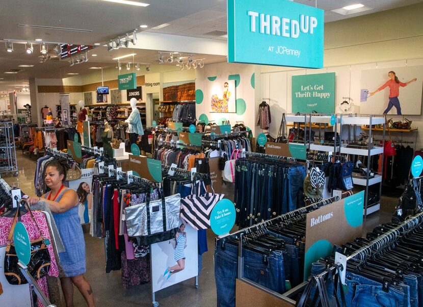 J.C. Penney employee Perla Valdivia racks clothes in the thredUP section at J.C. Penney...