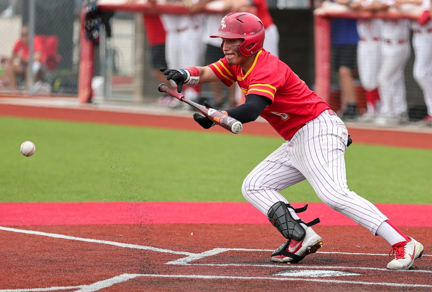 South Grand Prairie first baseman Jeremiah Darrough attempts a bunt against MacArthur during...