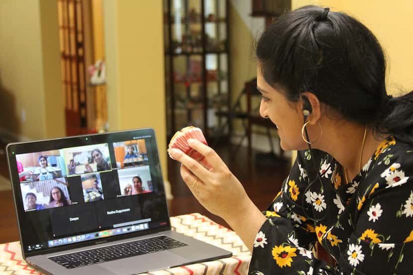 Jayashree Krishnan holds a muffin during an online baking class.