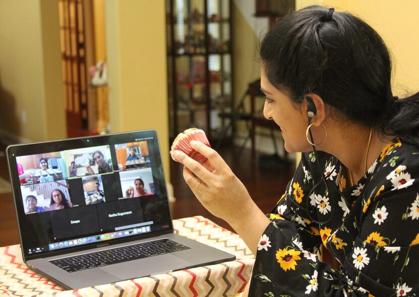 Jayashree Krishnan holds a muffin during an online baking class.