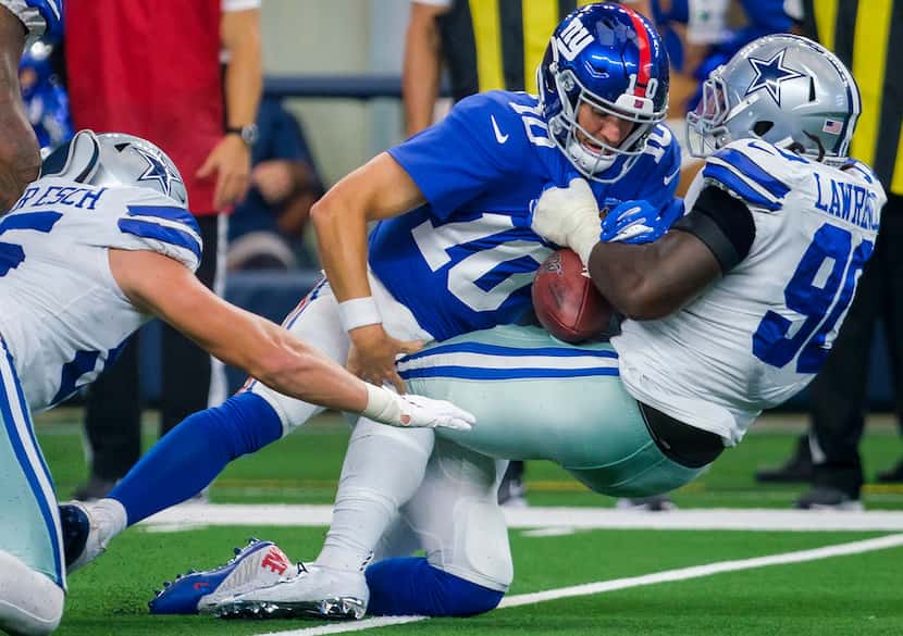 Dallas Cowboys defensive end Demarcus Lawrence (90) rips the ball away from New York Giants...