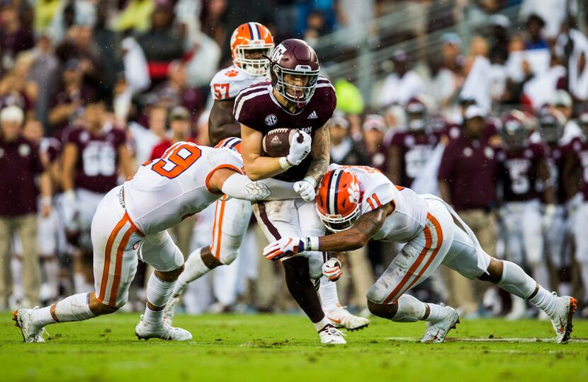FILE - Texas A&M tight end Jace Sternberger (81) is tackled by Clemson safeties Tanner Muse...