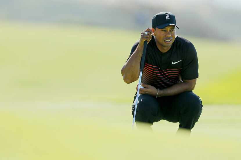 SAN DIEGO, CA - JANUARY 25:  Tiger Woods looks over a putt on the fourth green during the...