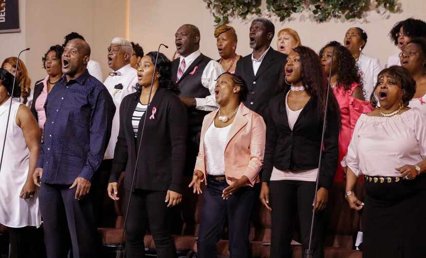 Members of the New Covenant Christian Fellowship Church Choir sing during Sunday service...