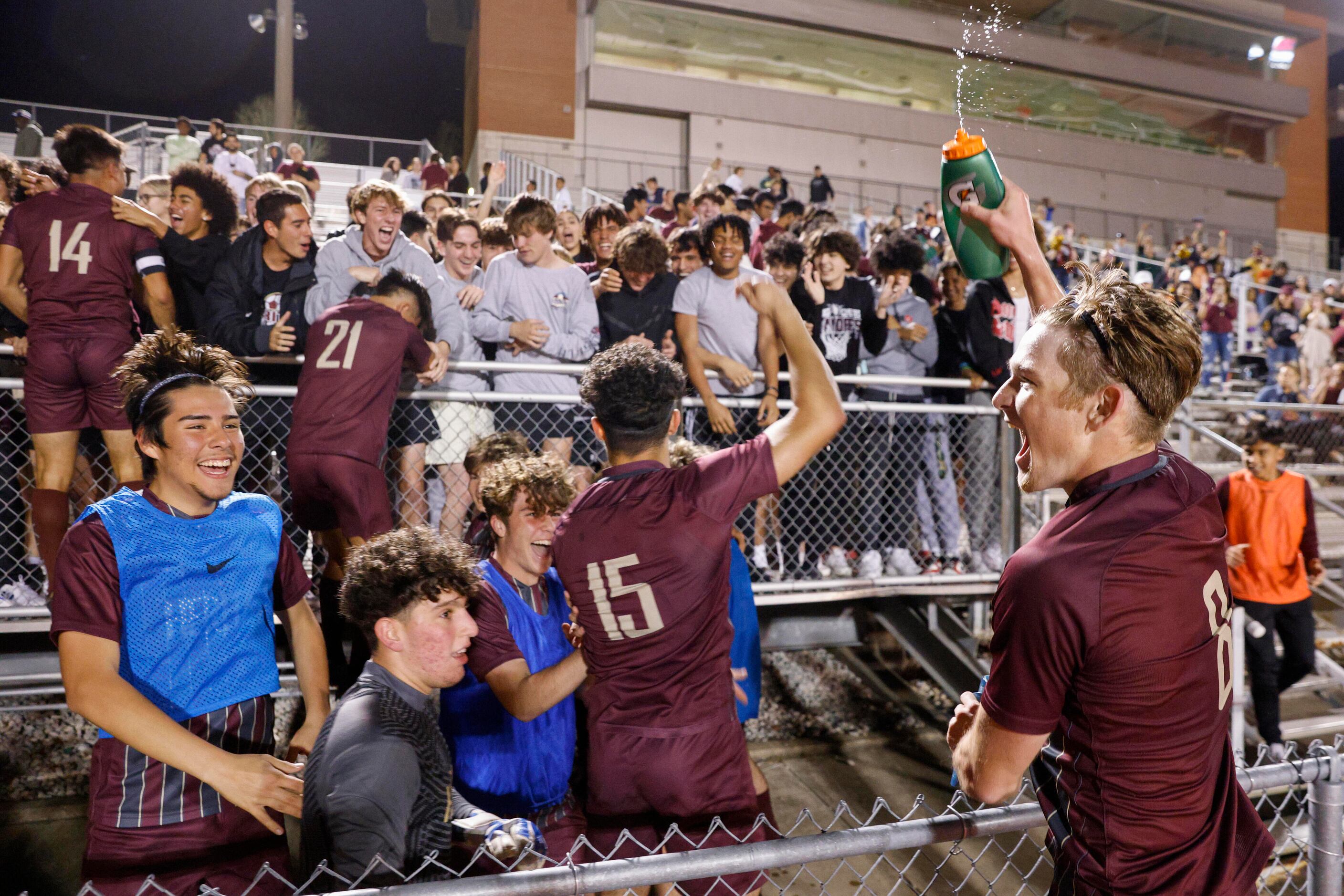 Frisco Heritage forward Jacob Culpepper (right) sprays water as he celebrates a bi-district...