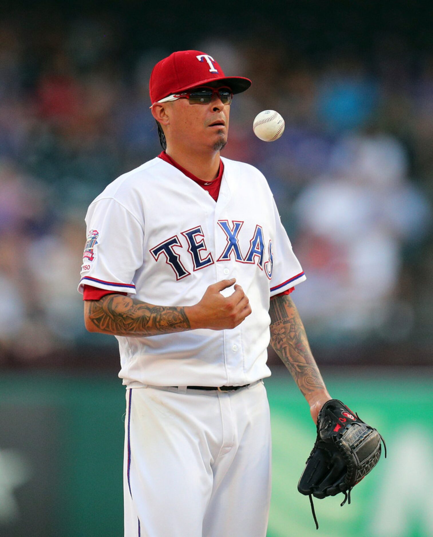 Texas Rangers pitcher Jesse Chavez (53) stands on the mound as he waits for a visit to the...