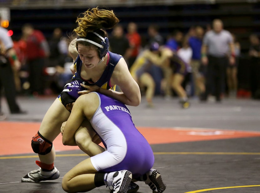 Cypress Ranch's Kayla Fitts (top) wrestles Weslaco's Melissa Ibarra during the girls...