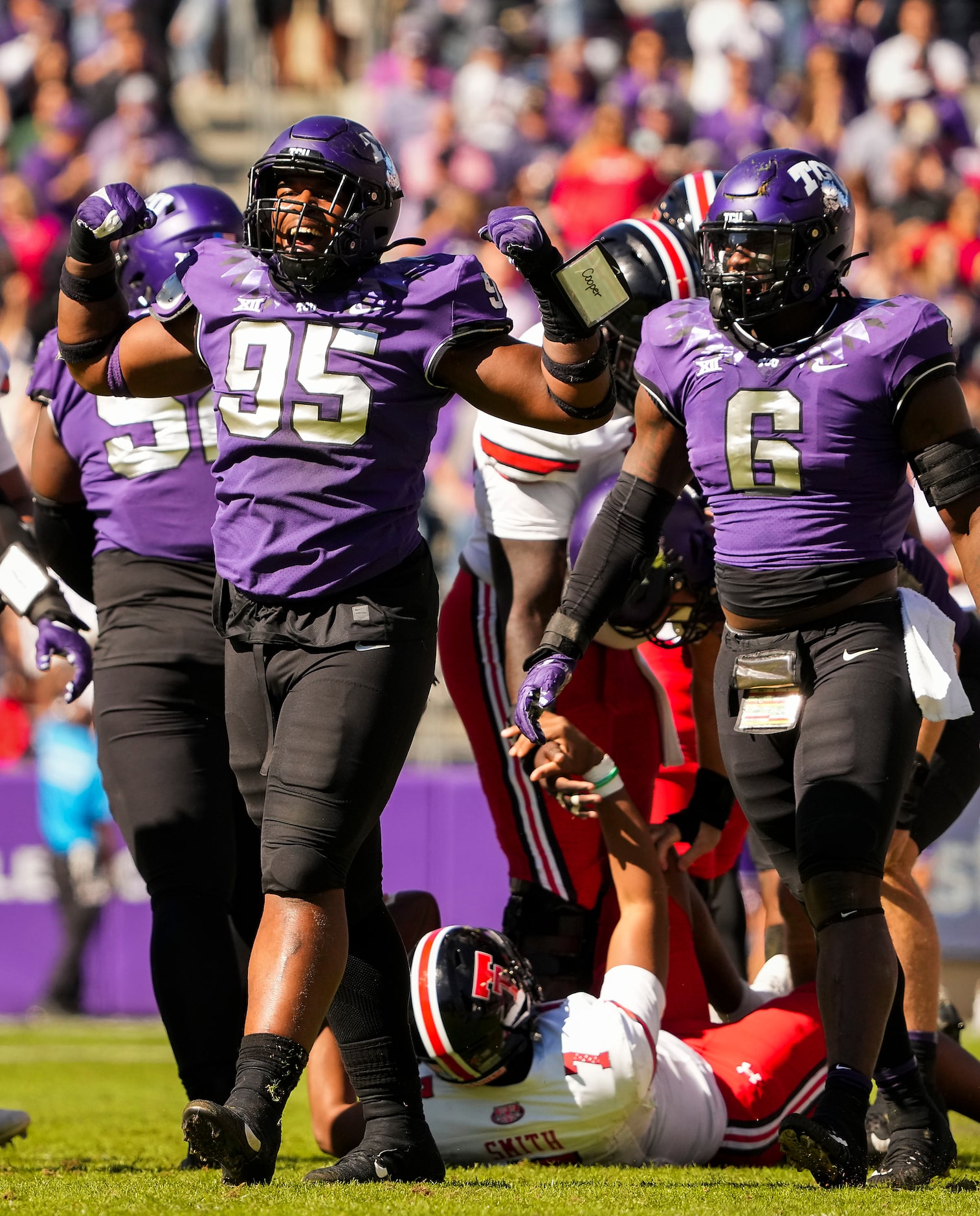 TCU defensive lineman Terrell Cooper (95) celebrates with teammates after stopping Texas...