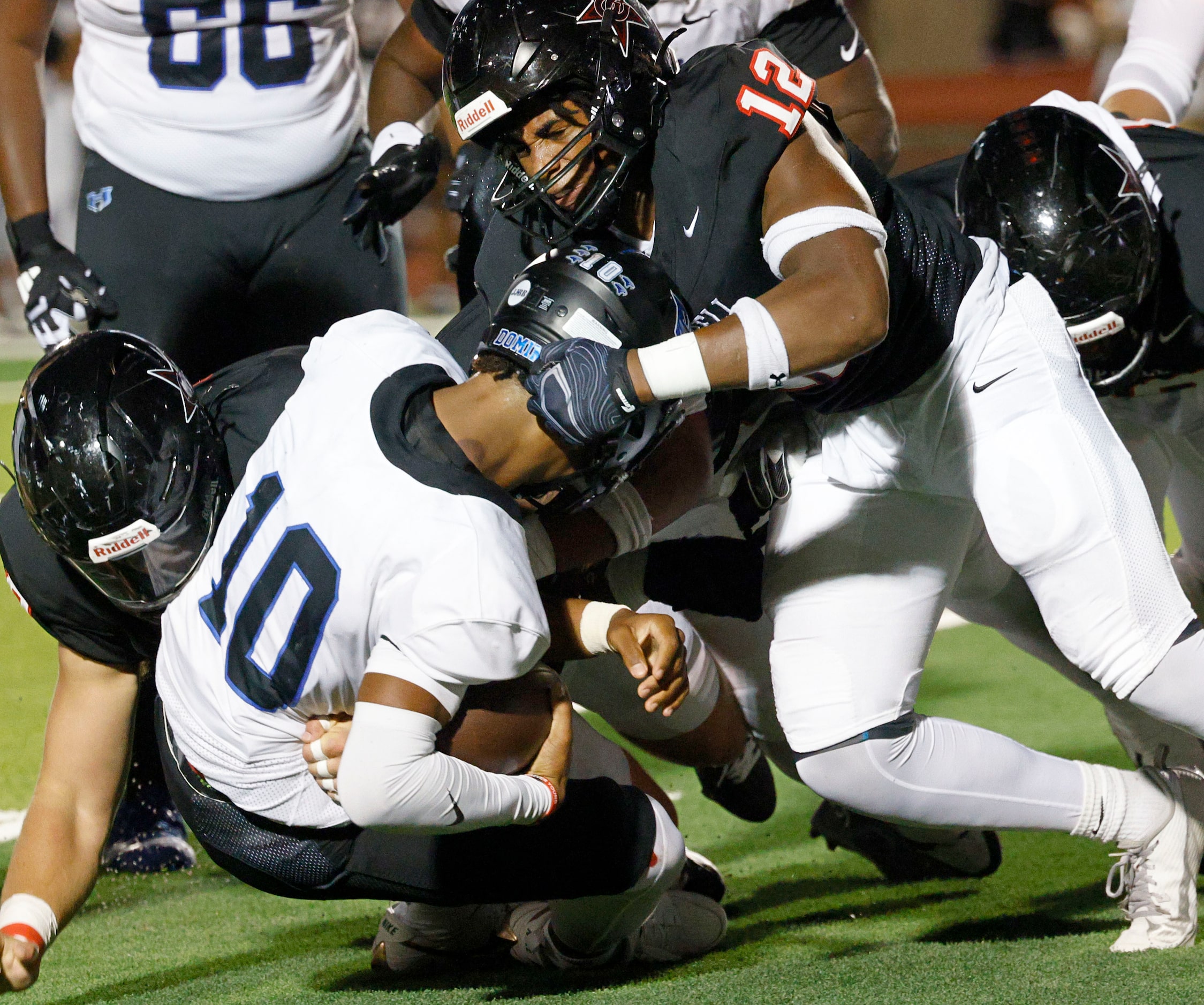 Hebron's quarterback Patrick Crayton Jr. (10) is sacked by Coppell's Uche Odimegwu (12) in...