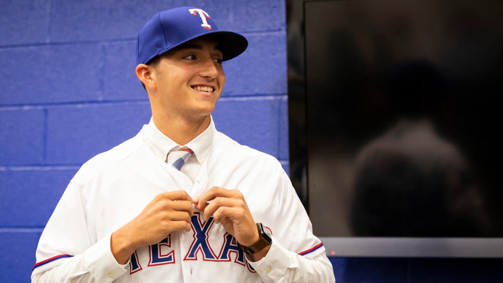 Texas Rangers 2nd round pick, pitcher Owen White of Jesse Carson (NC) High School, dons a...