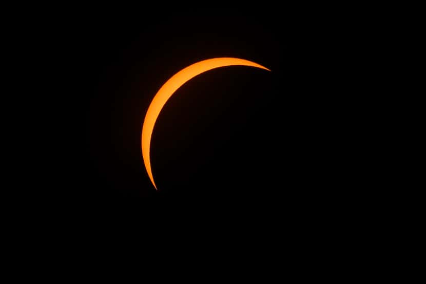 The moon is seen as it starts passing in front of the sun during a total solar eclipse at...
