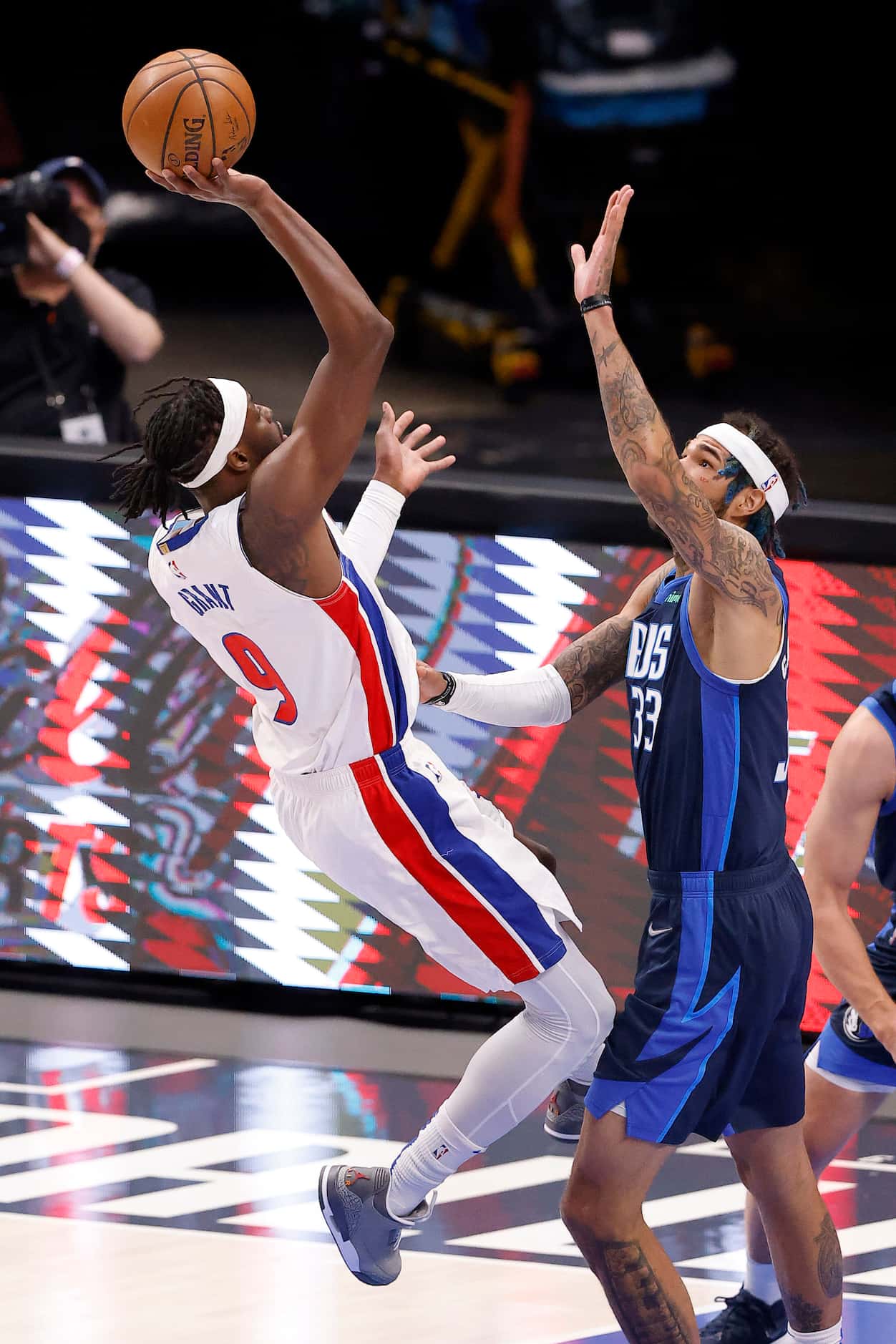 Detroit Pistons forward Jerami Grant (9) draws the foul from Dallas Mavericks center Willie...