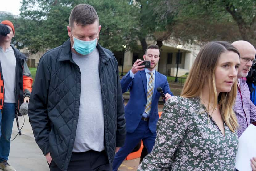 Texas men's basketball coach Chris Beard, second left, walks out of the Travis County Jail...