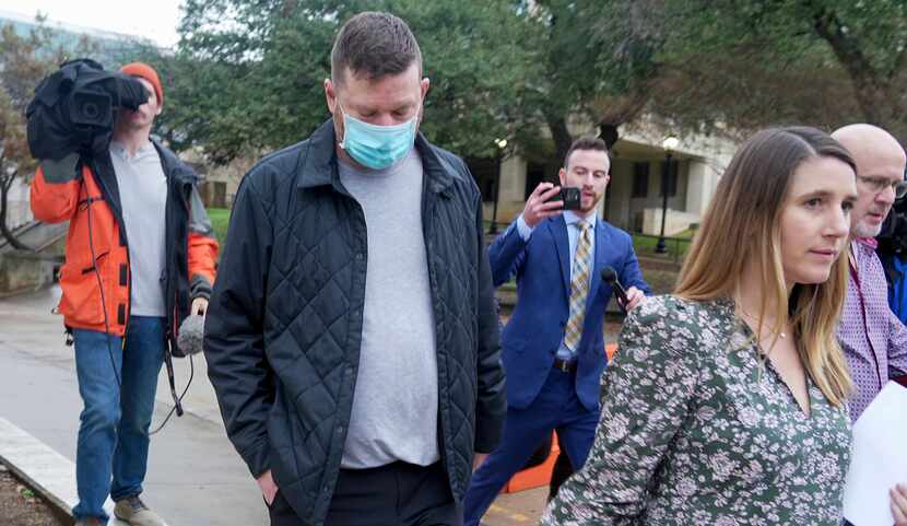 Texas men's basketball coach Chris Beard, second left, walks out of the Travis County Jail...