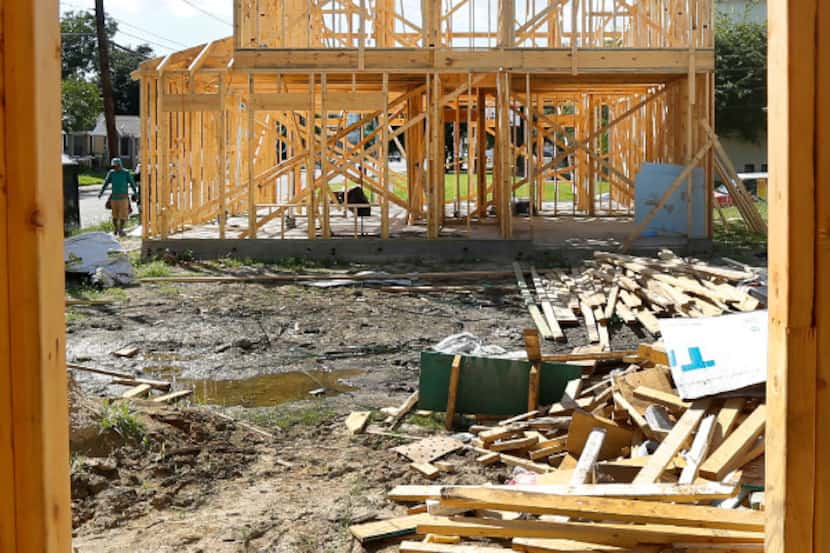 A pair of new homes are under construction along Malcolm X Blvd in South Dallas, Monday,...