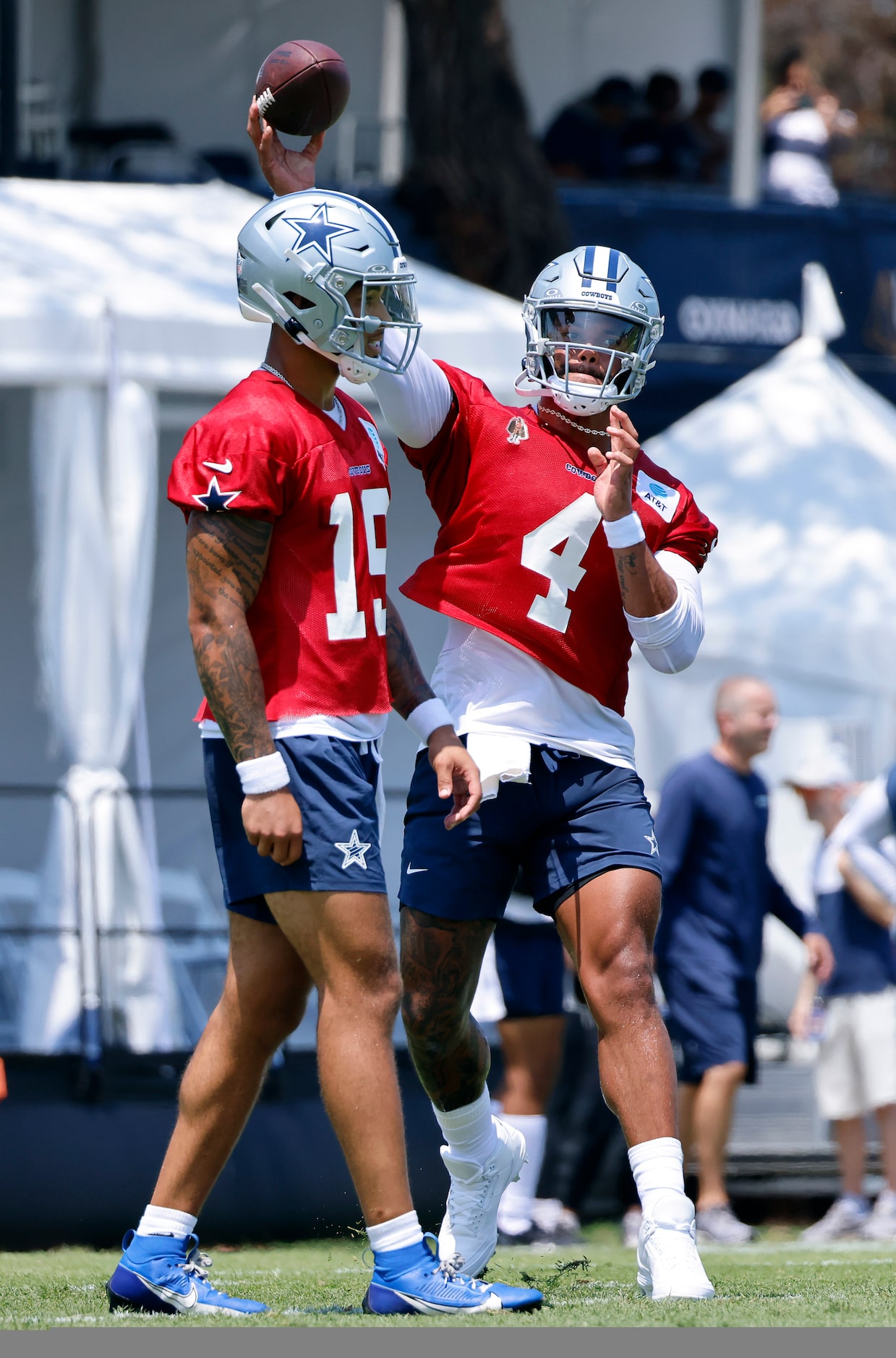 Dallas Cowboys quarterback Dak Prescott (4) throws a pass over fellow quarterback Trey Lance...