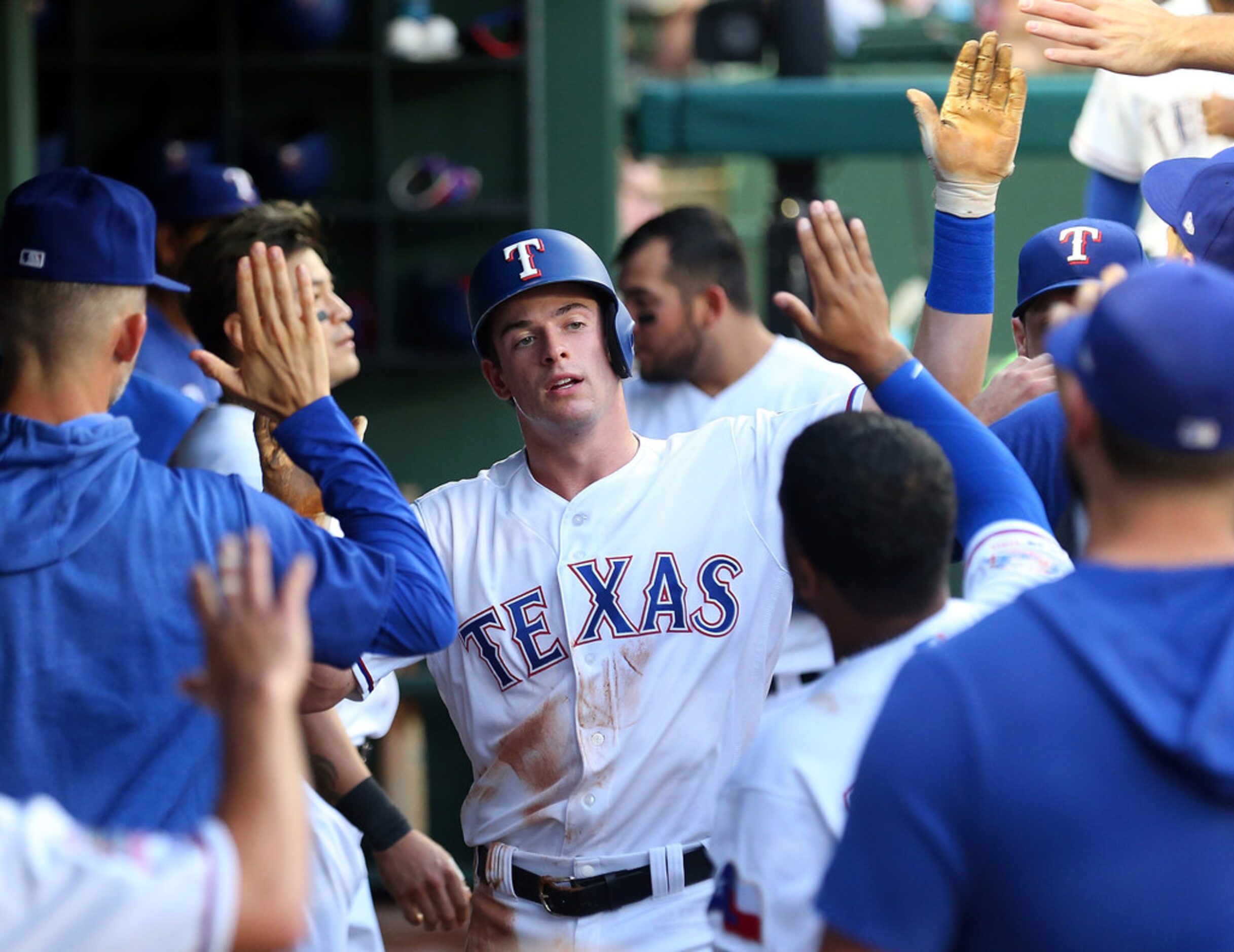 ARLINGTON, TEXAS - AUGUST 30: Nick Solak #15 of the Texas Rangers is greeted in the dugout...