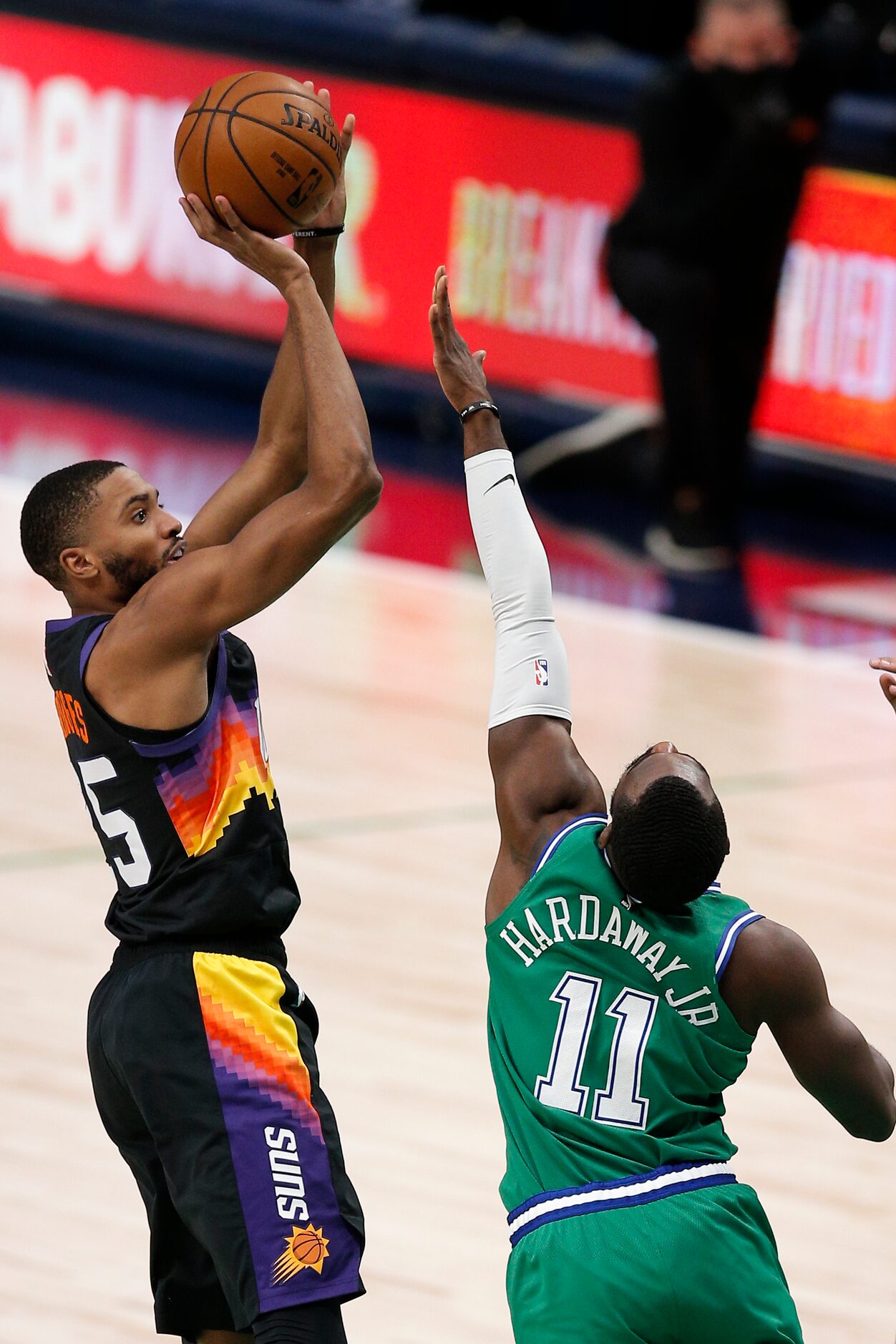 Phoenix Suns forward Mikal Bridges (25) attempts a shot as Dallas Mavericks forward Tim...