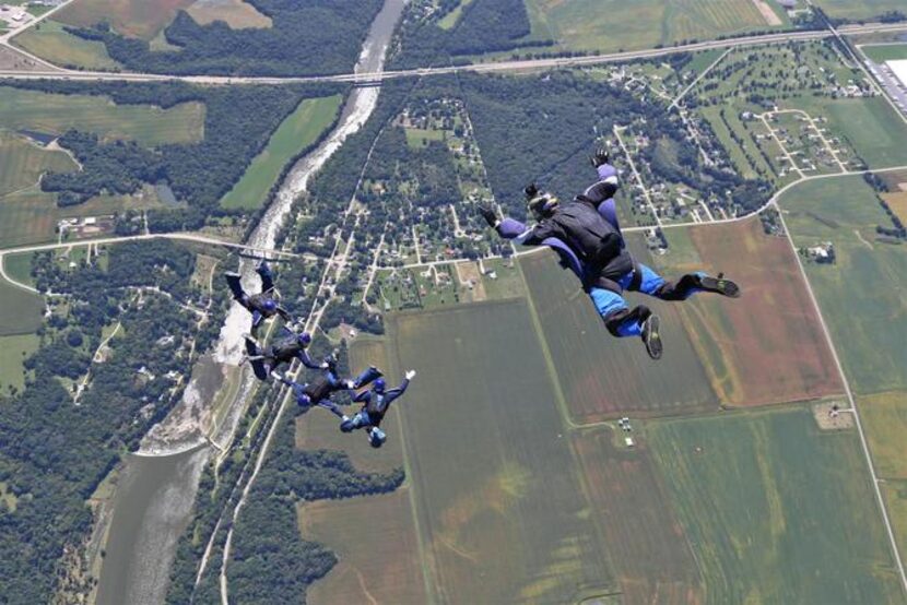 
Members of Dallas 350 get into formation while being filmed by cameraman Alan Levy (right)...