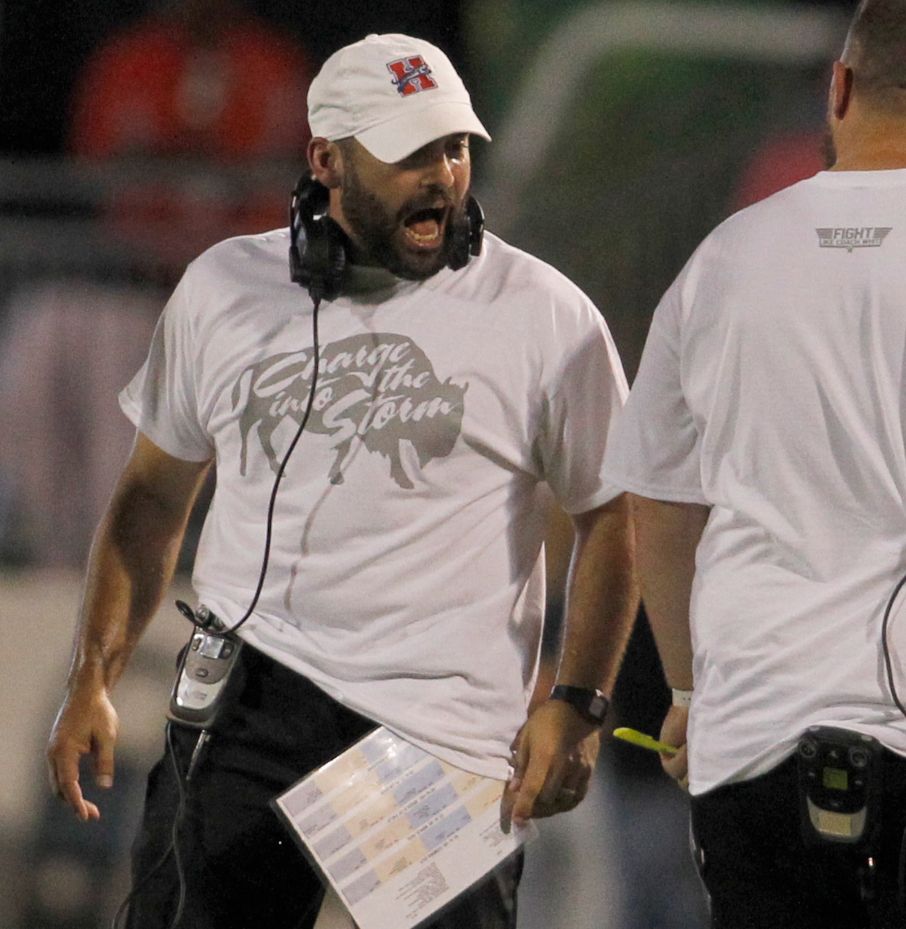 Midlothian Heritage head coach Eric Edwards converses with one of the team assistants during...