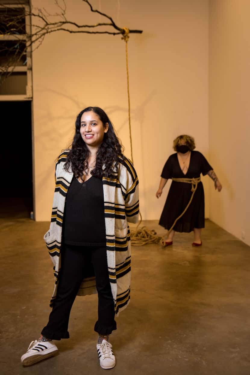 Dallas artist Christian Cruz poses for a photo in front of her piece, 'Piñata Dance'...