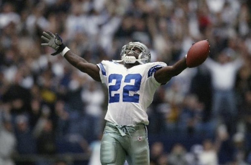 Running Back Emmitt Smith #22 of the Dallas Cowboys celebrates beating the NFL rushing...
