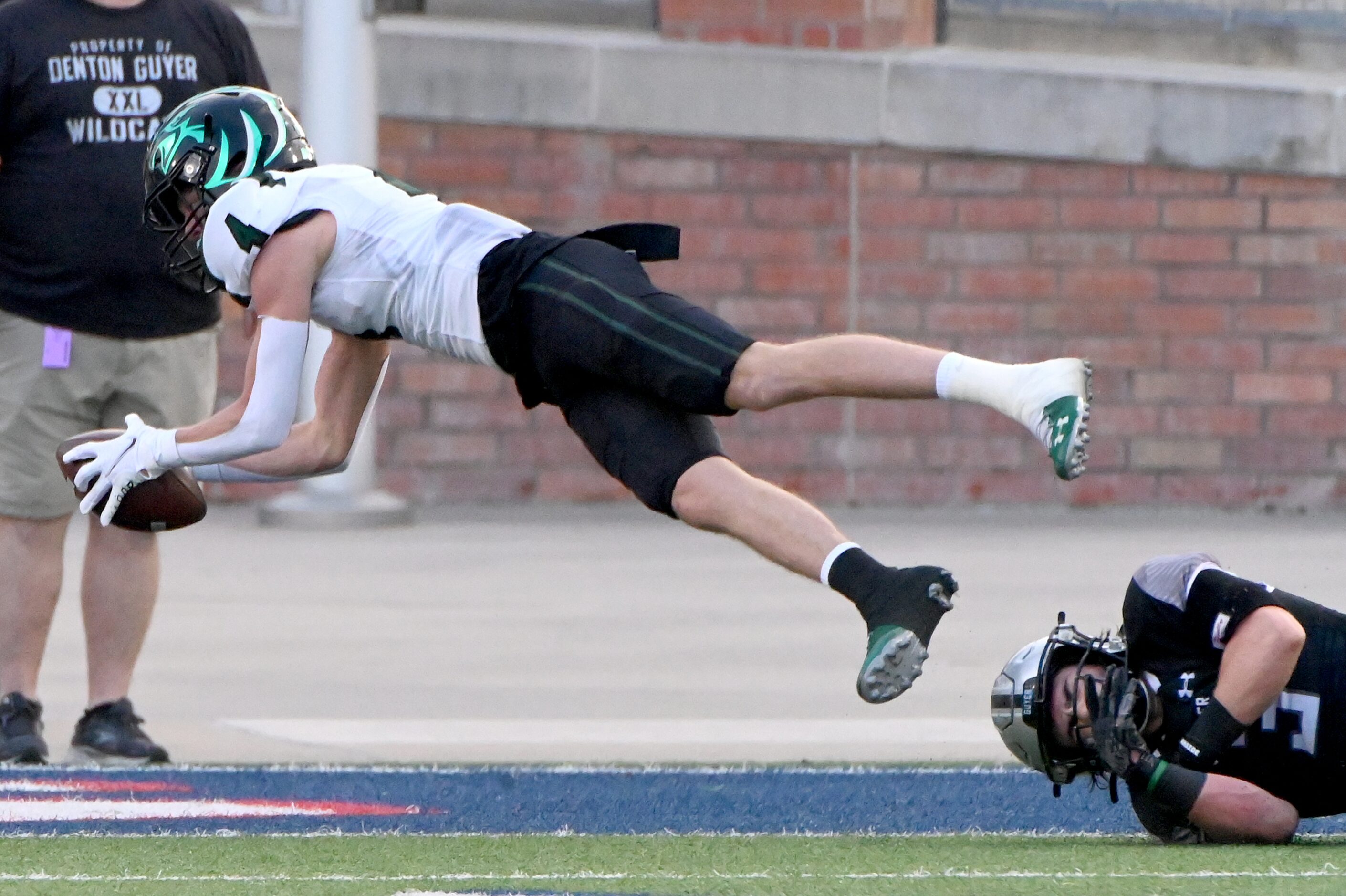 Prosper's Houston Hawkins (4) drives for a touchdown past Denton Guyer's Jaden Powell (3) in...