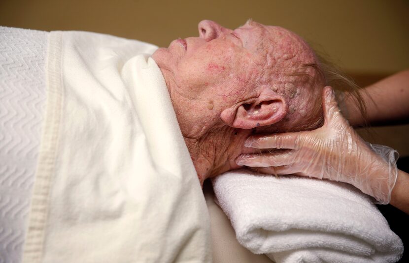 Charles Powers, left, gets a massage from Cate Cloft, a licensed massage therapist, at C. C....