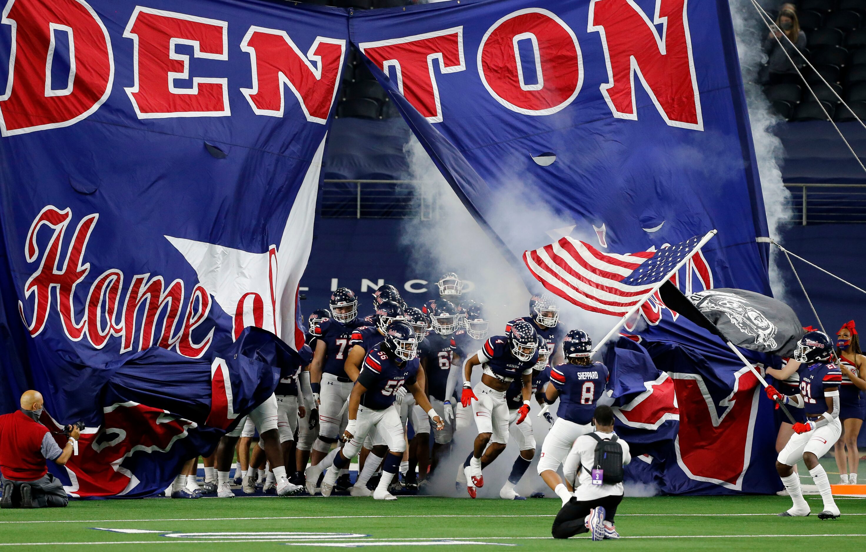 The Denton Ryan football team enters the field before the first half of the Class 5A...