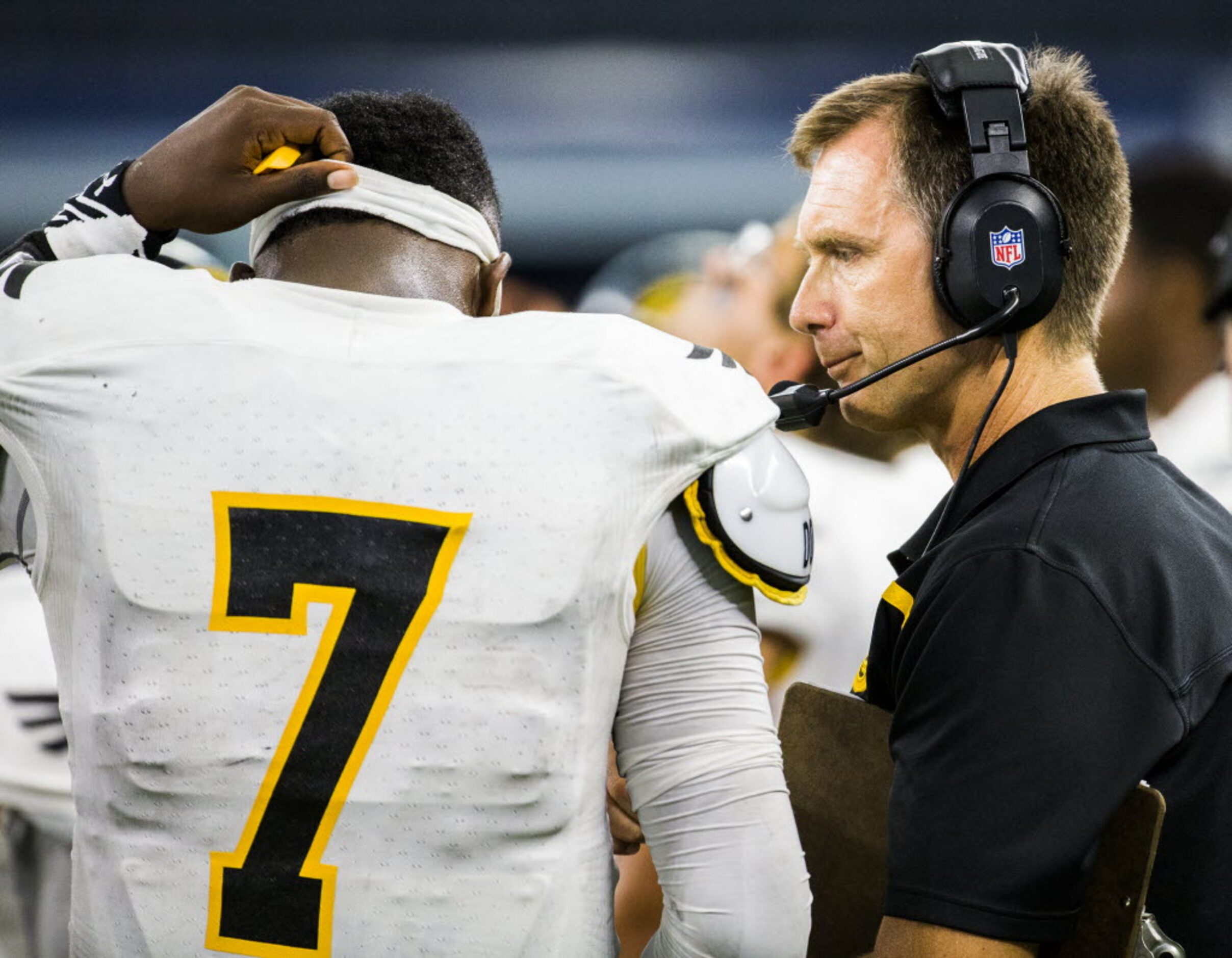 Garland head coach Jeff Jordan talks to Garland quarterback Jacoby Williams (7) on the...