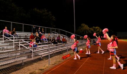 Members of First Baptist Academy's squad lead cheers on the Gainesville State School side of...