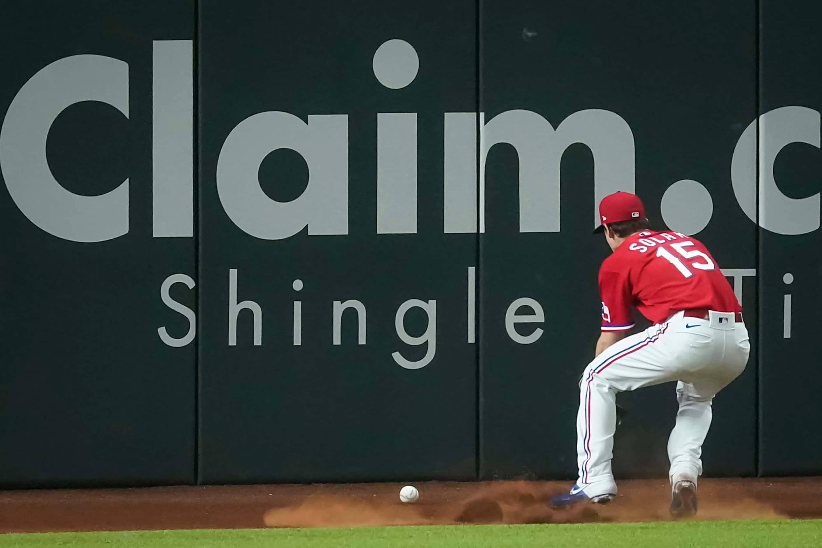 Texas Rangers left fielder Nick Solak chases an RBI triple off the bat of Houston Astros...
