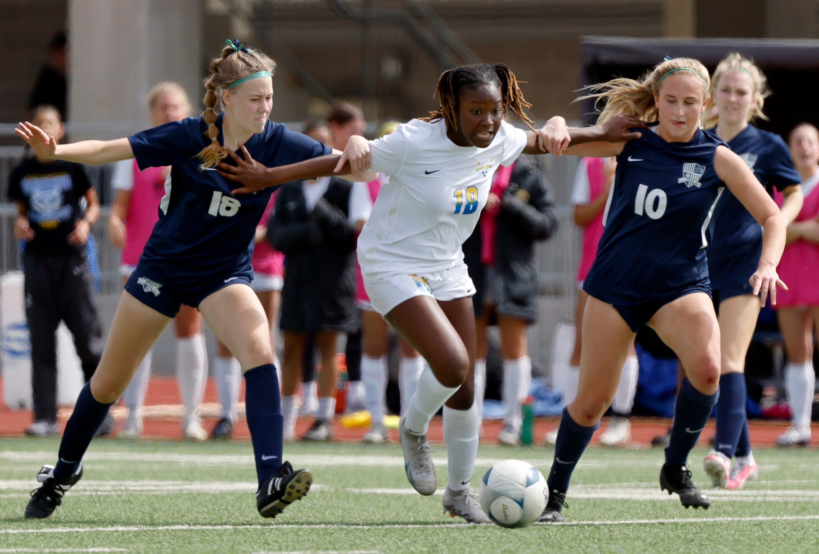 Frisco’s London Young (18) fights off Frisco Reedy’s Emma Taylor (18) and Alena Ultes (10)...