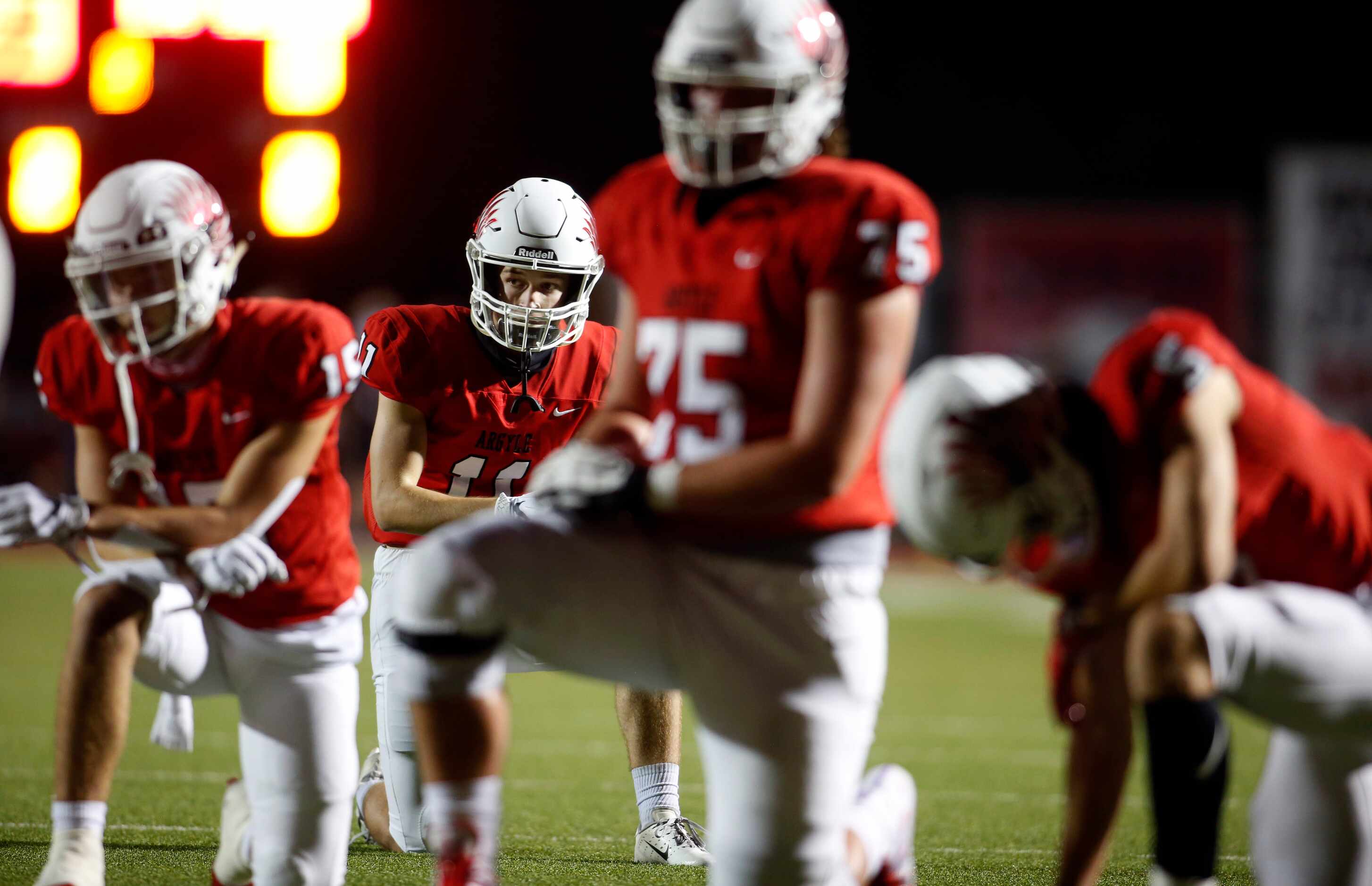 Argyle receiver Ward McCollum,(11) in background, along with other Eagles offensive players,...