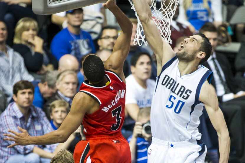 Dallas Mavericks center Salah Mejri (50) defends a shot by Portland Trail Blazers guard C.J....