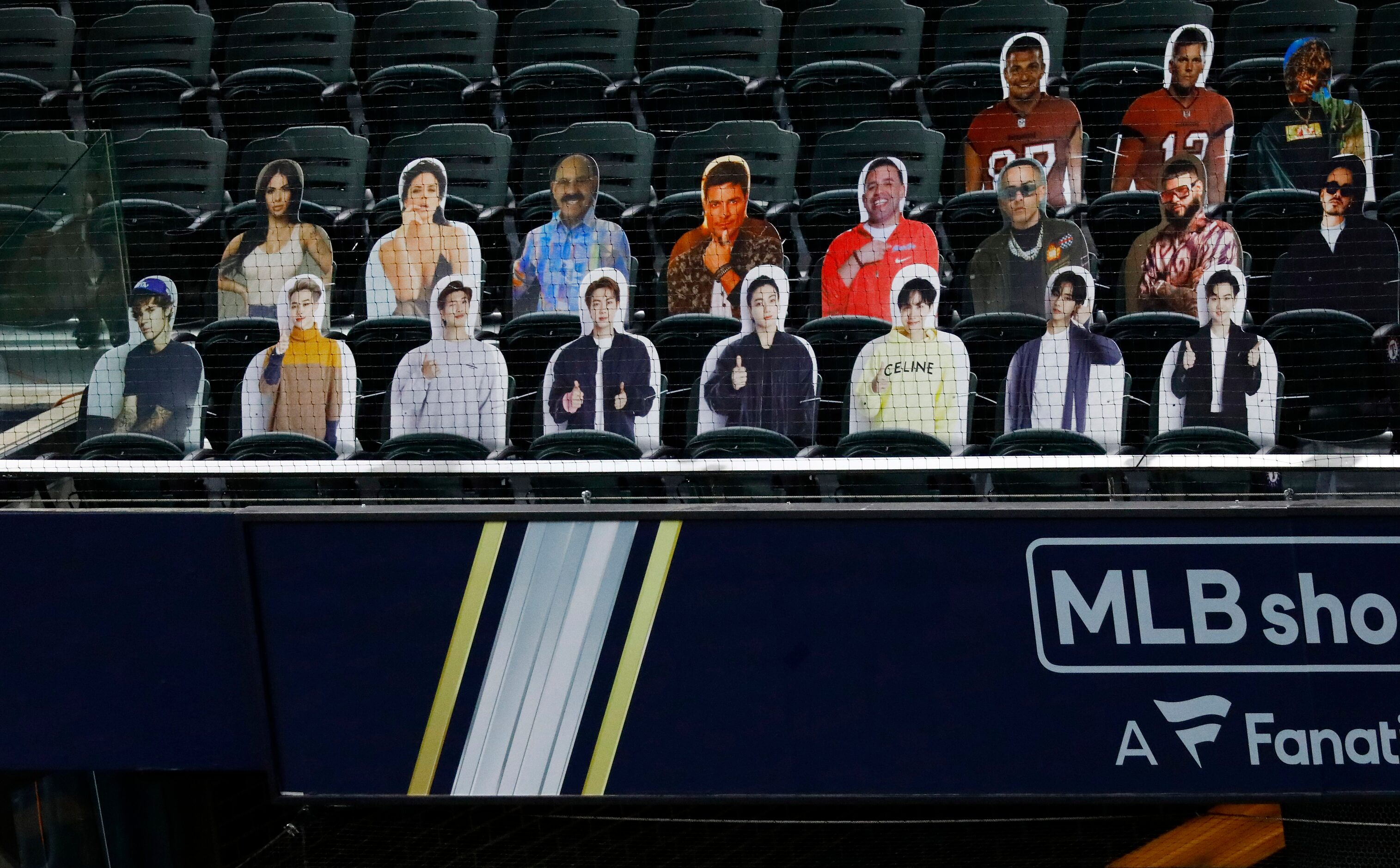 Cutouts of the Korean boy band, BTS, line the front row of at Globe Life Field in Arlington...