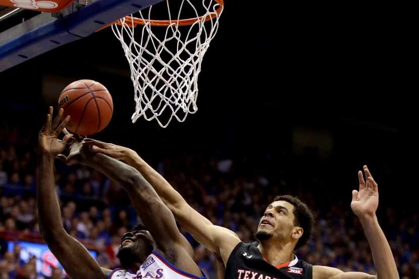 Kansas' Udoka Azubuike (35) is fouled by Texas Tech's Zach Smith (11) as he shoots during...