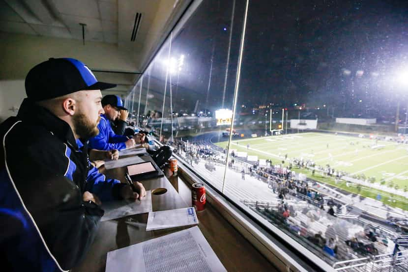 (L to R) Hebron High School's football scout Adam Gotwalt scouts the Denton Guyer team...