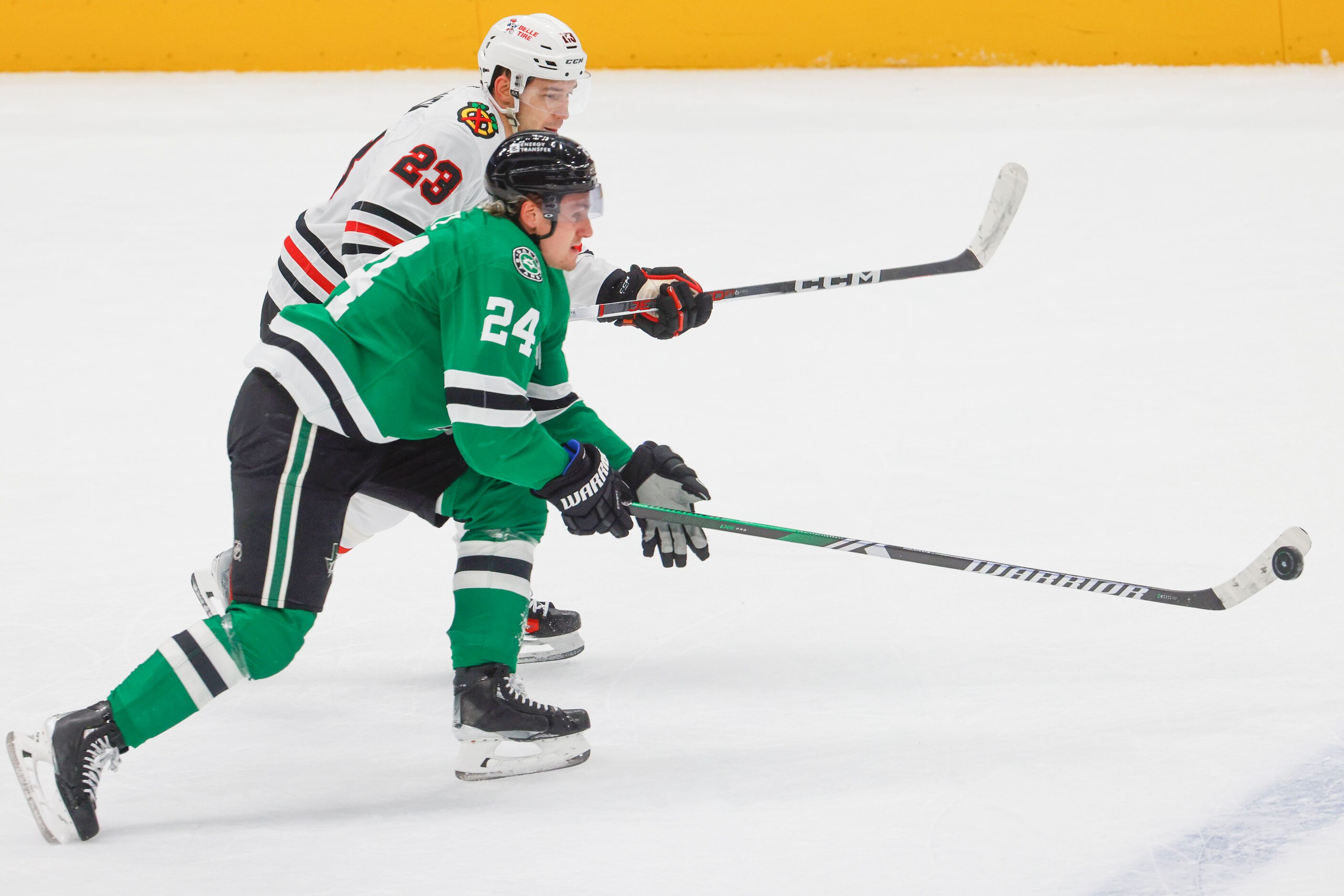 Chicago Blackhawks center Philipp Kurashev (23) tries to stop Dallas Stars center Roope...