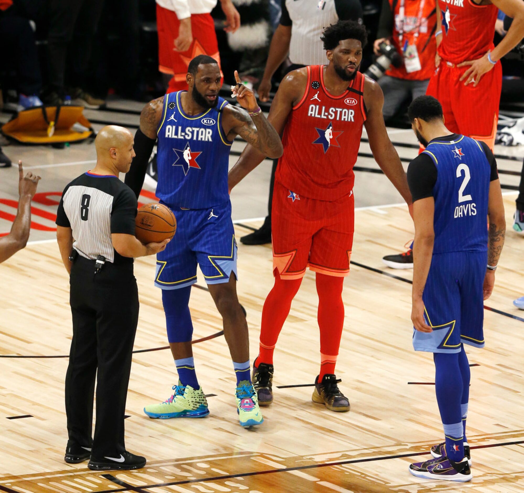 Team Giannis's Joel Embiid (24) talks to Team LeBron's Anthony Davis (2) next to LeBron...