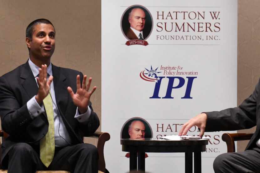 Ajit Pai, left, FCC Chairman, answers a question from Tom Giovanetti, president of the...