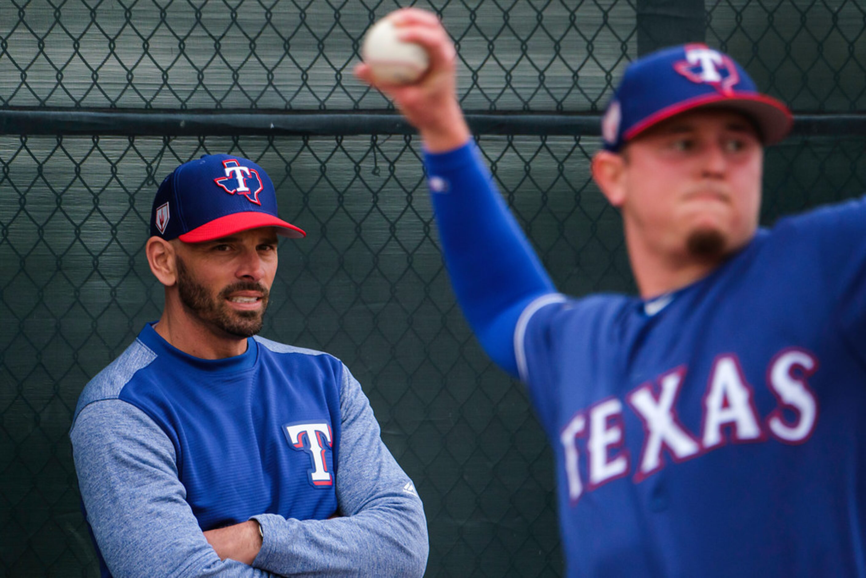 Texas Rangers manager Chris Woodward watches as pitcher Nick Gardewine throws in the bullpen...