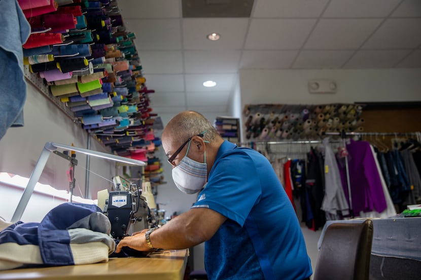 Owner John Seok works on alterations at Preston Royal Cleaners and Lucy's Tailor in Dallas...