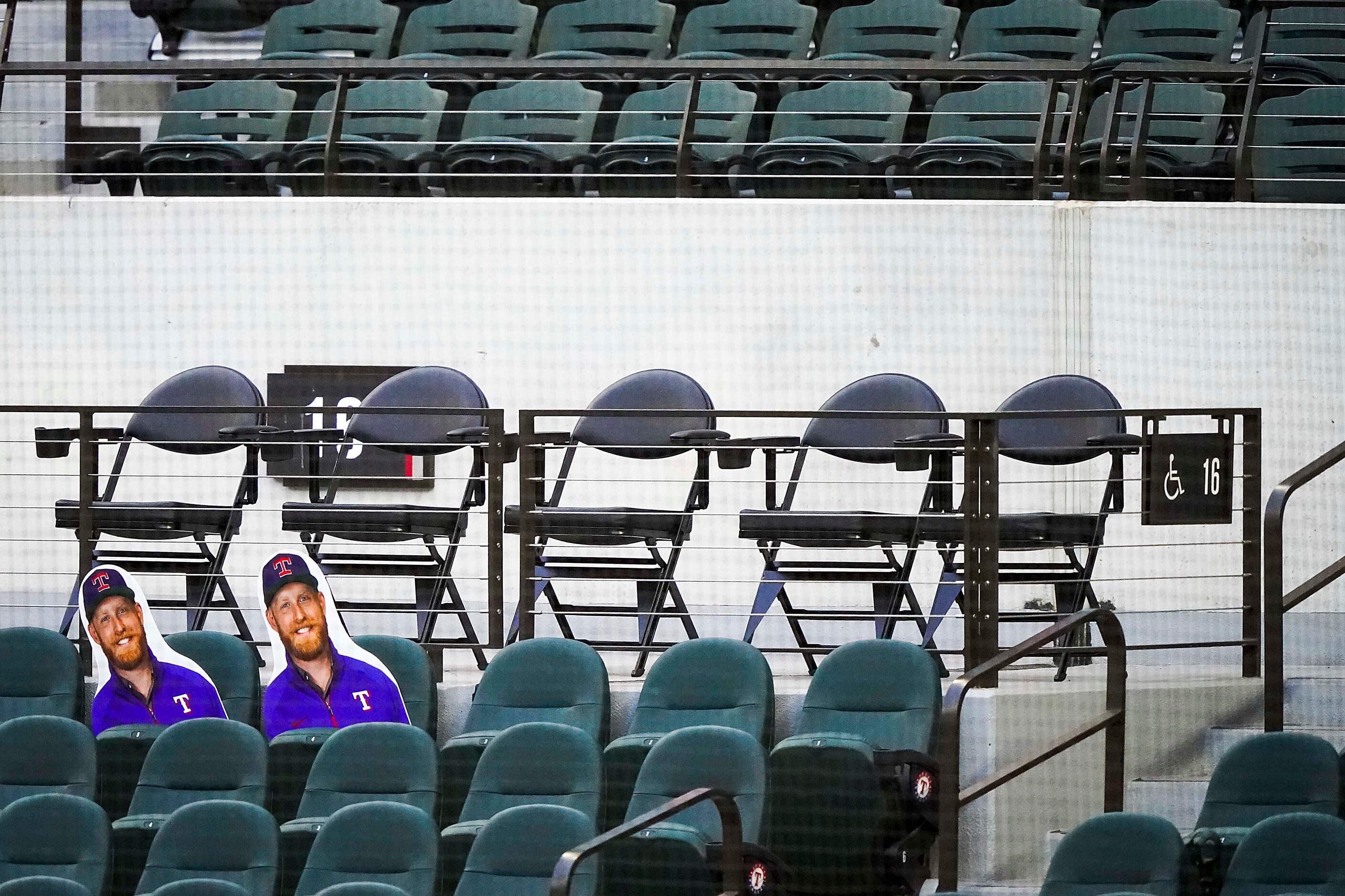 A pair of cutout faces rest in the empty lower seating bowl during an intrasquad game in...