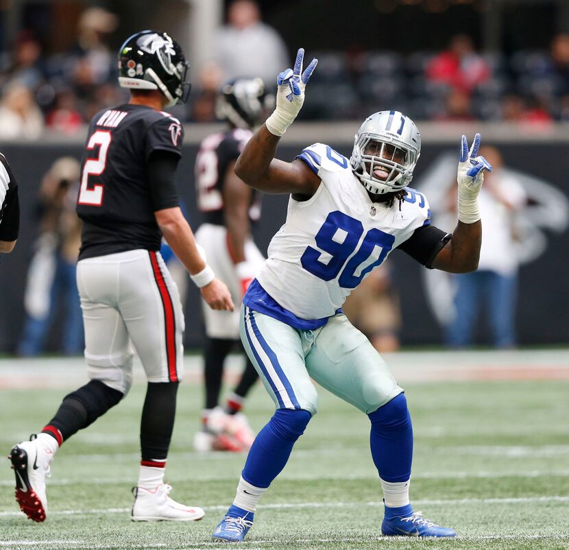 Dallas Cowboys defensive end Demarcus Lawrence (90) dances after he sacked Atlanta Falcons...