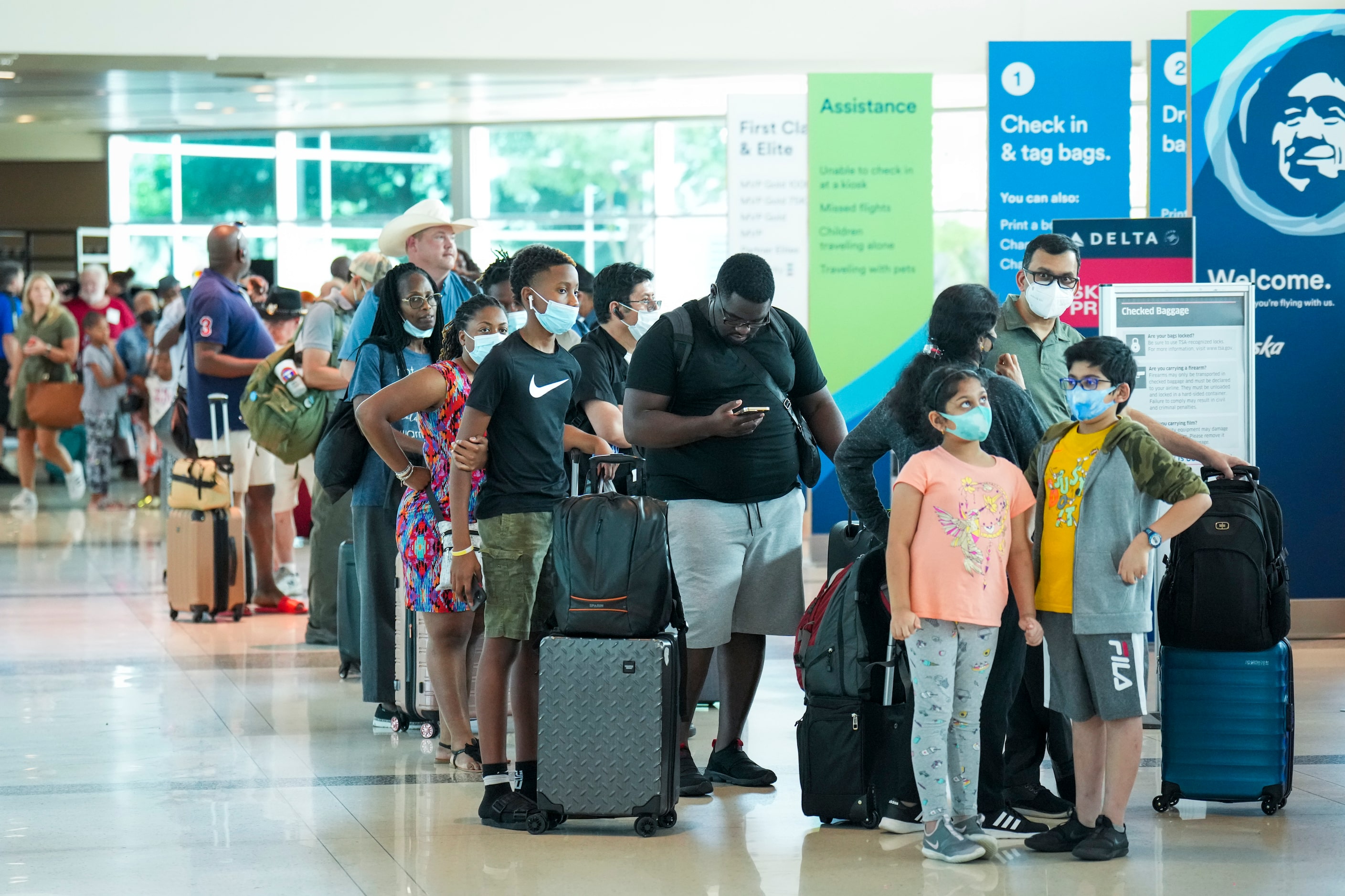 Passengers in line to check in for a flight at Dallas Love Field Airport on Monday, July 25,...