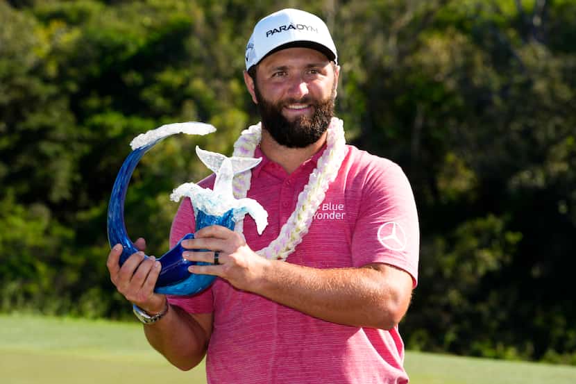 Jon Rahm, of Spain, holds the champions trophy after the final round of the Tournament of...