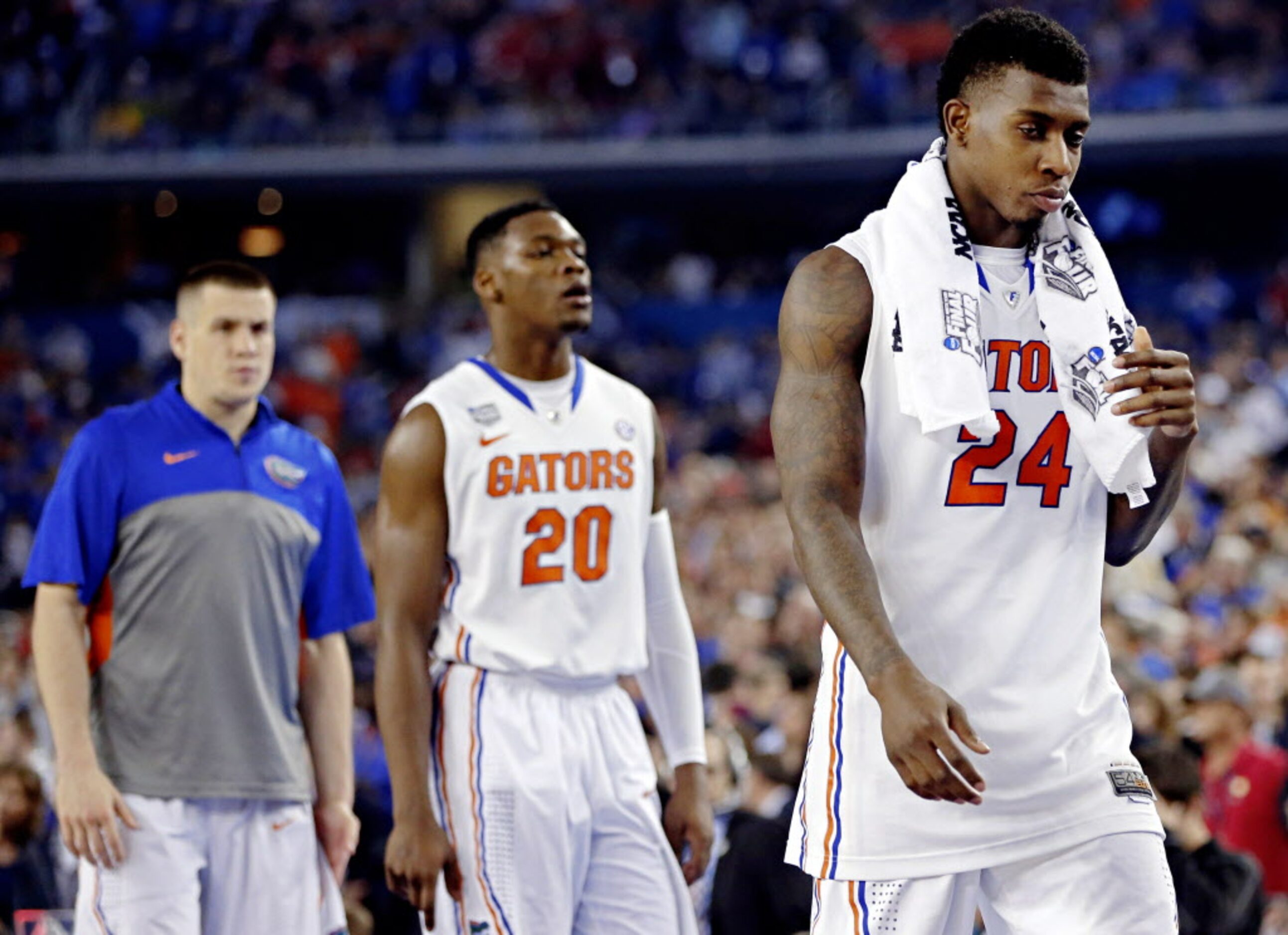 Florida Gators forward Casey Prather (24) and guard Michael Frazier II walk off the court...