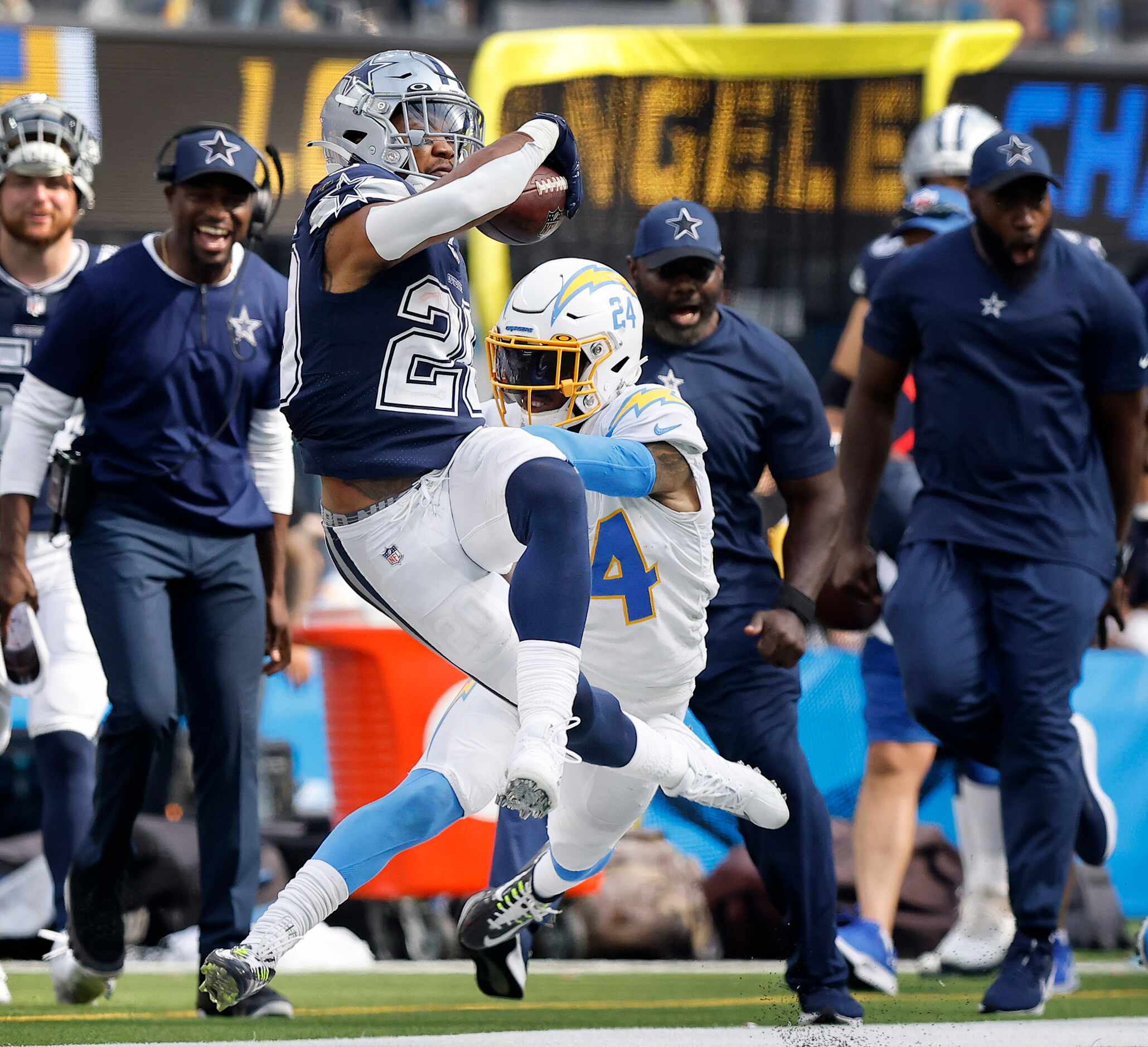 Dallas Cowboys running back Tony Pollard (20) is pushed out of bounds by Los Angeles...